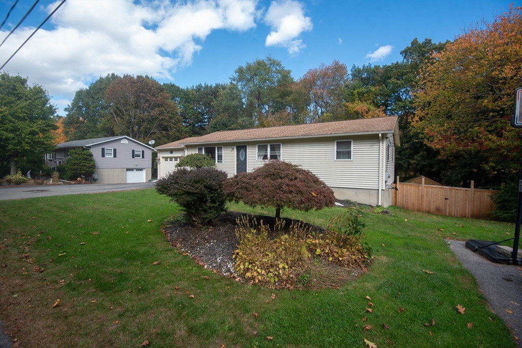 18 Birchwood Road Rutland, MA 01543 - Photo 3 of 42 a backyard of a house with table and chairs plants and large tree