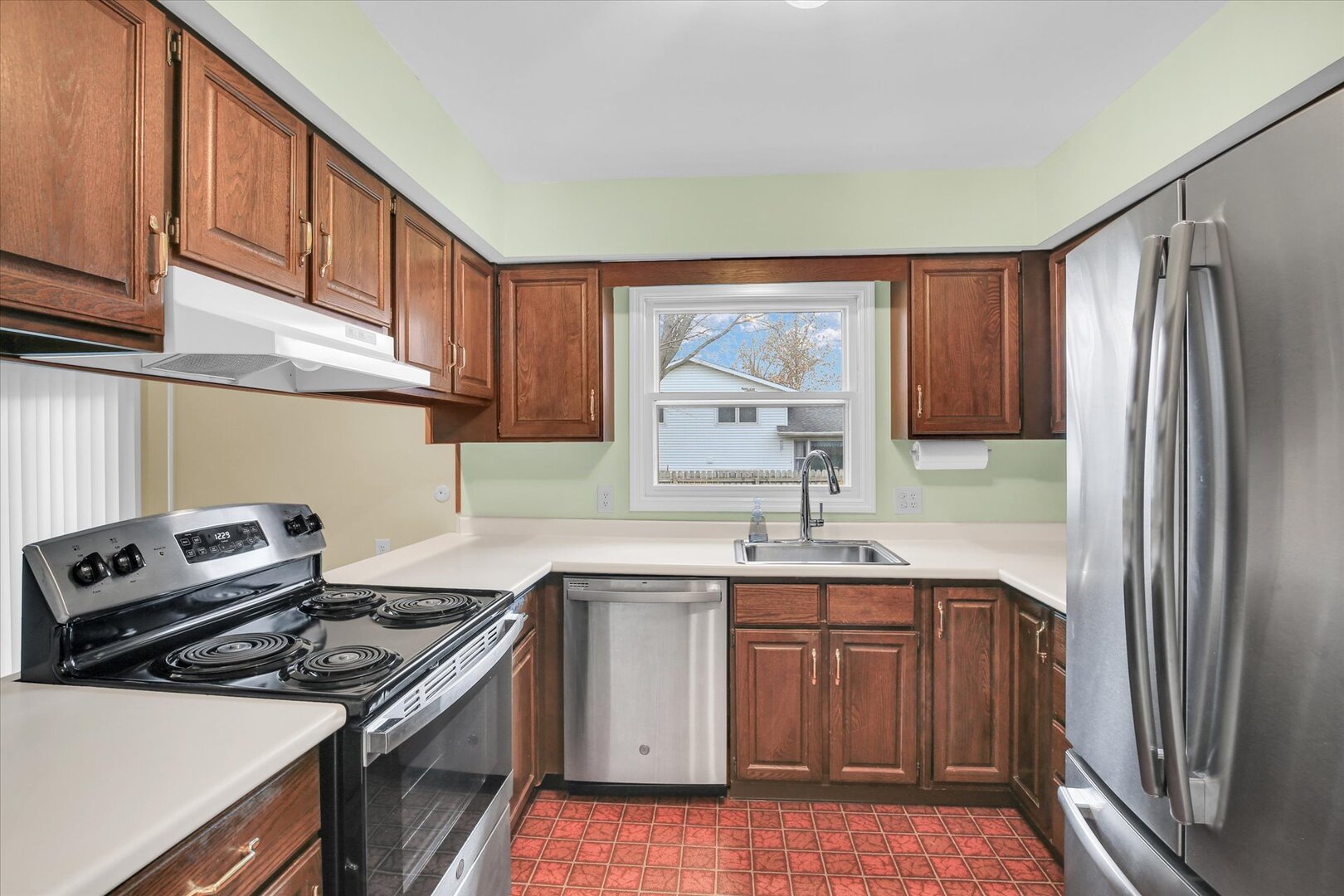 2302 Blackthorn Drive Champaign, IL 61821 - Photo 13 of 31 a kitchen with a sink stove and refrigerator