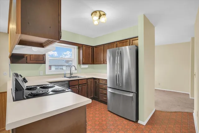 a kitchen with a refrigerator sink and stove