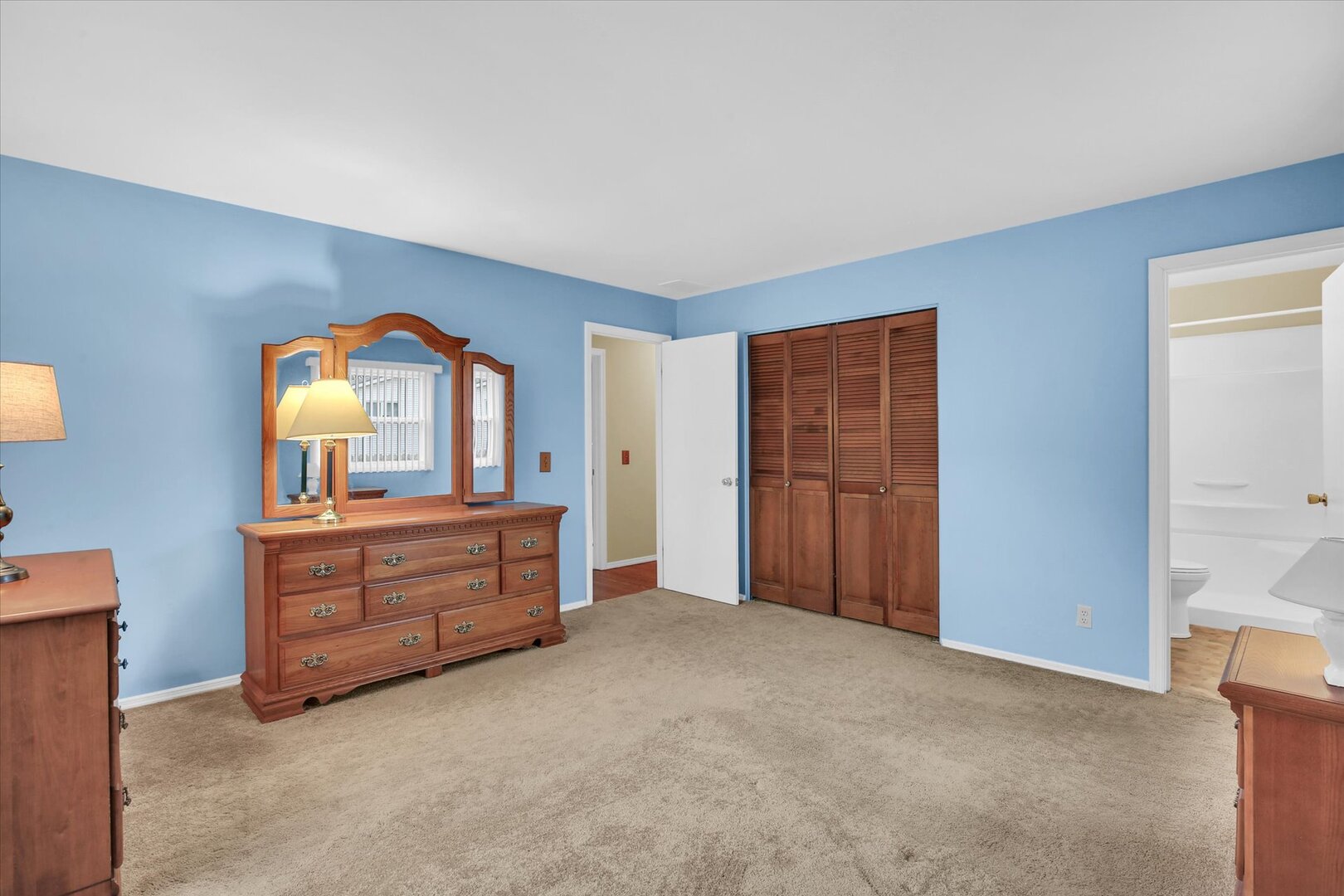 2302 Blackthorn Drive Champaign, IL 61821 - Photo 22 of 31 a room with a dresser and a mirror