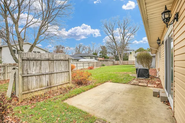 a backyard of a house with table and chairs