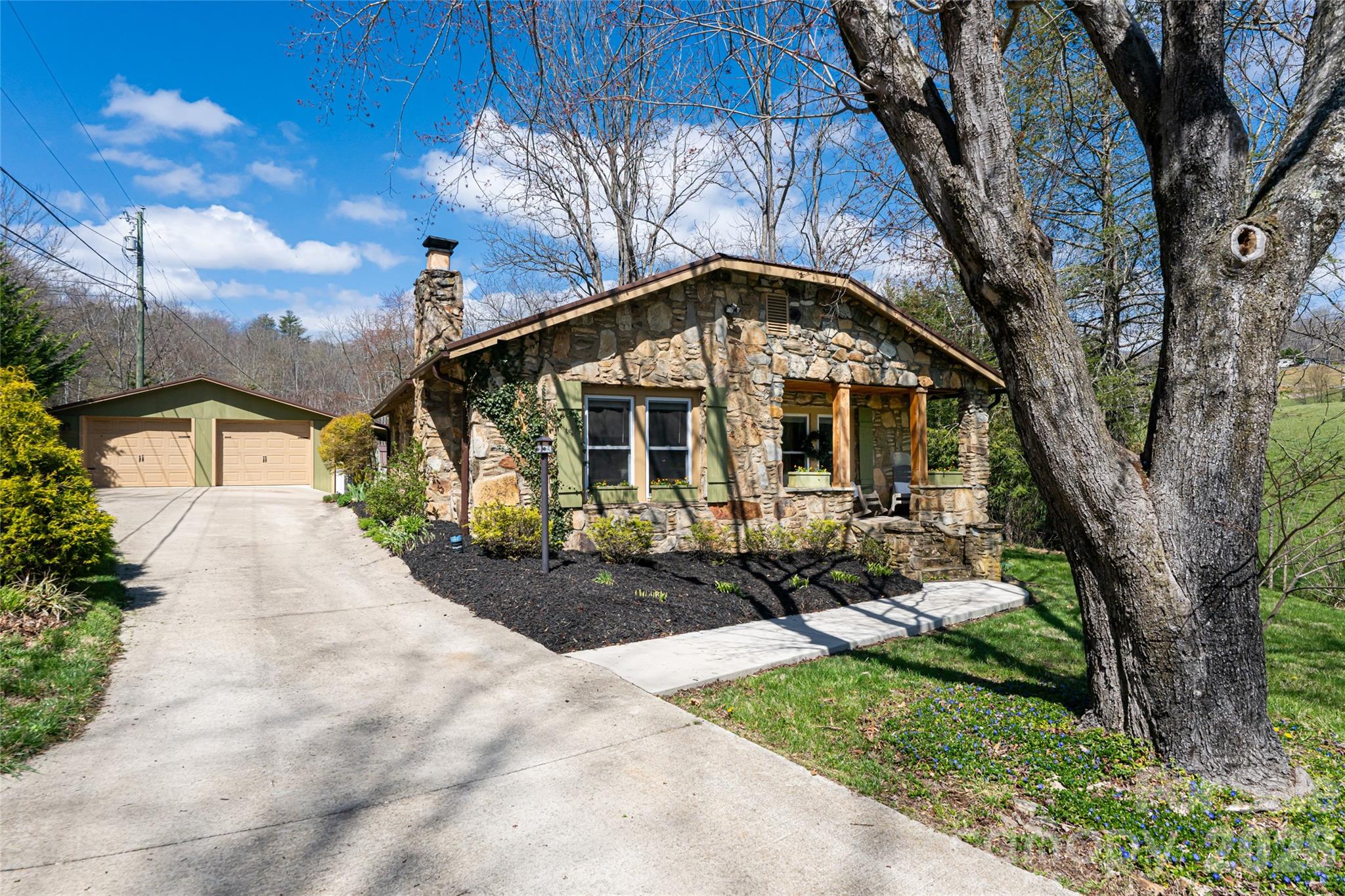 86 Rolling Hills Road Canton, NC 28716 - Photo 1 of 48 a front view of a house with a garden