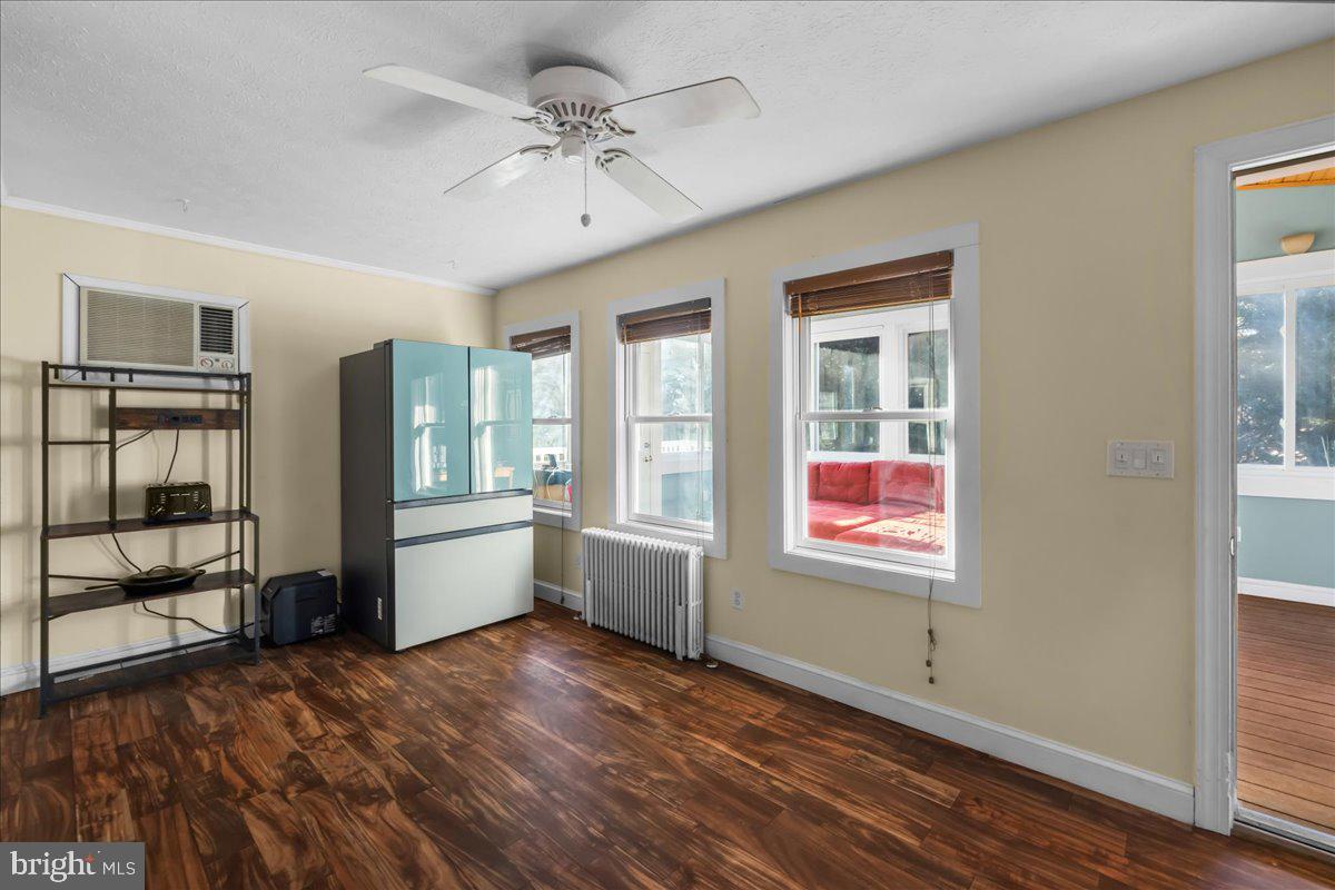 227 Miller Street Winchester, VA 22601 - Photo 14 of 51 a view of an empty room with window and wooden floor