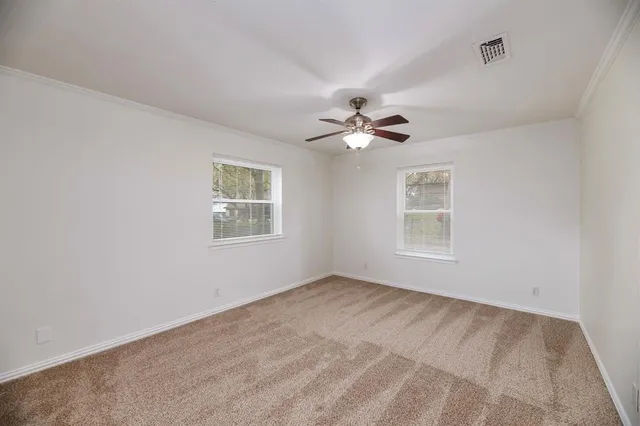 a view of an empty room with windows