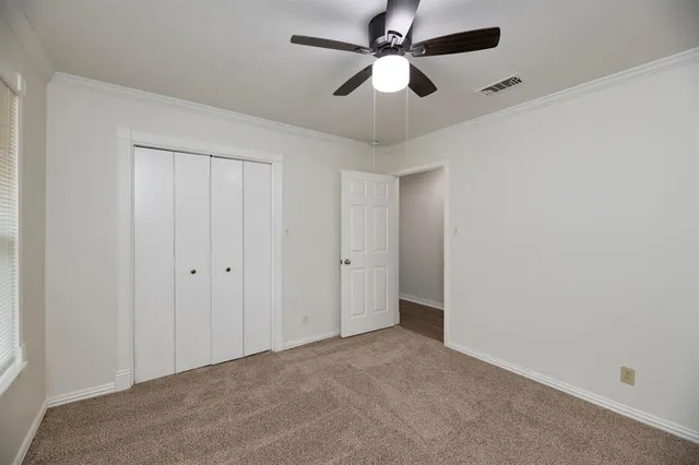 an empty room with a fan and a fan