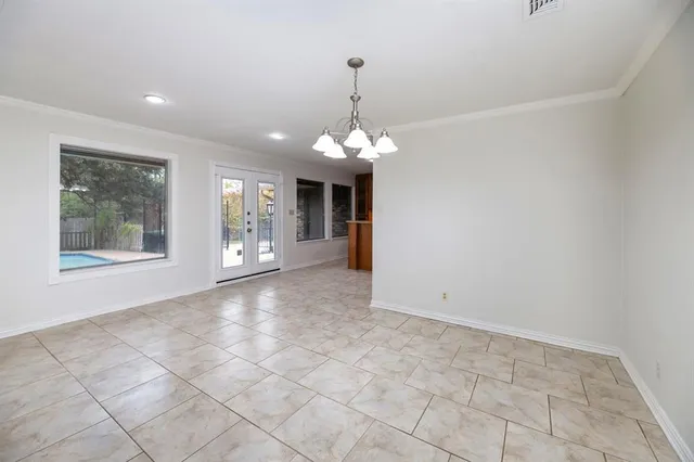 a view of a room with window and chandelier