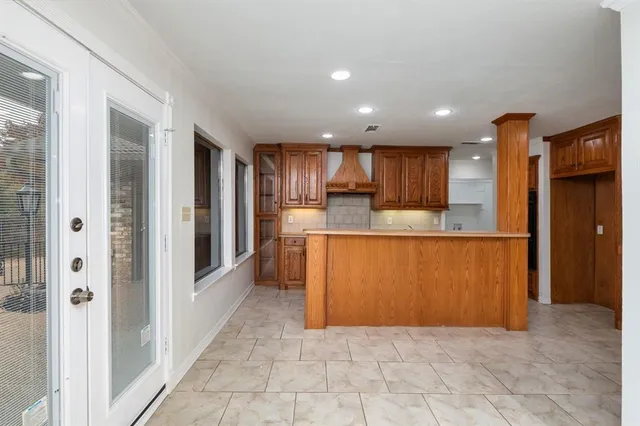 a large kitchen with stainless steel appliances granite countertop a refrigerator and a sink