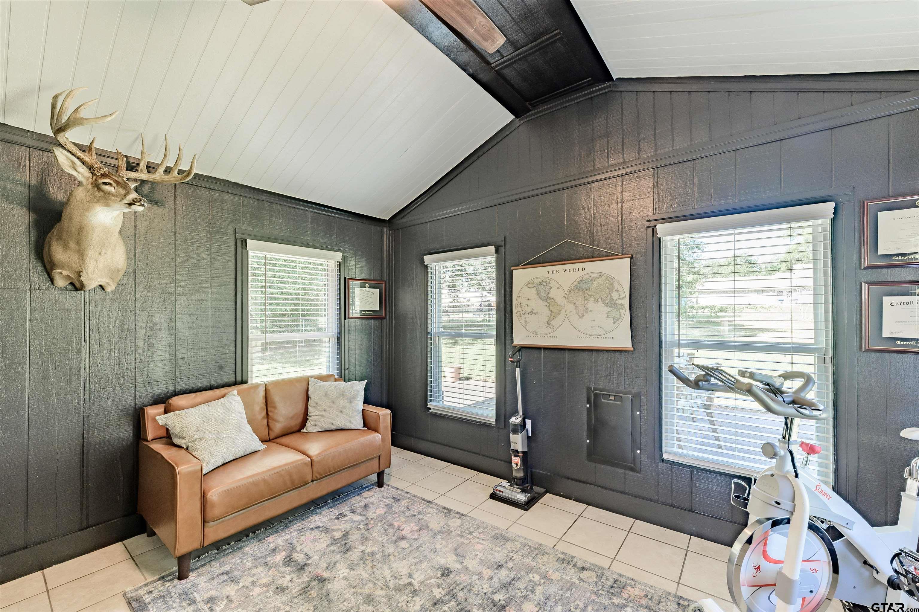 5921 Springbrook Drive Tyler, TX 75707 - Photo 12 of 39 a living room with furniture a window and a flat screen tv