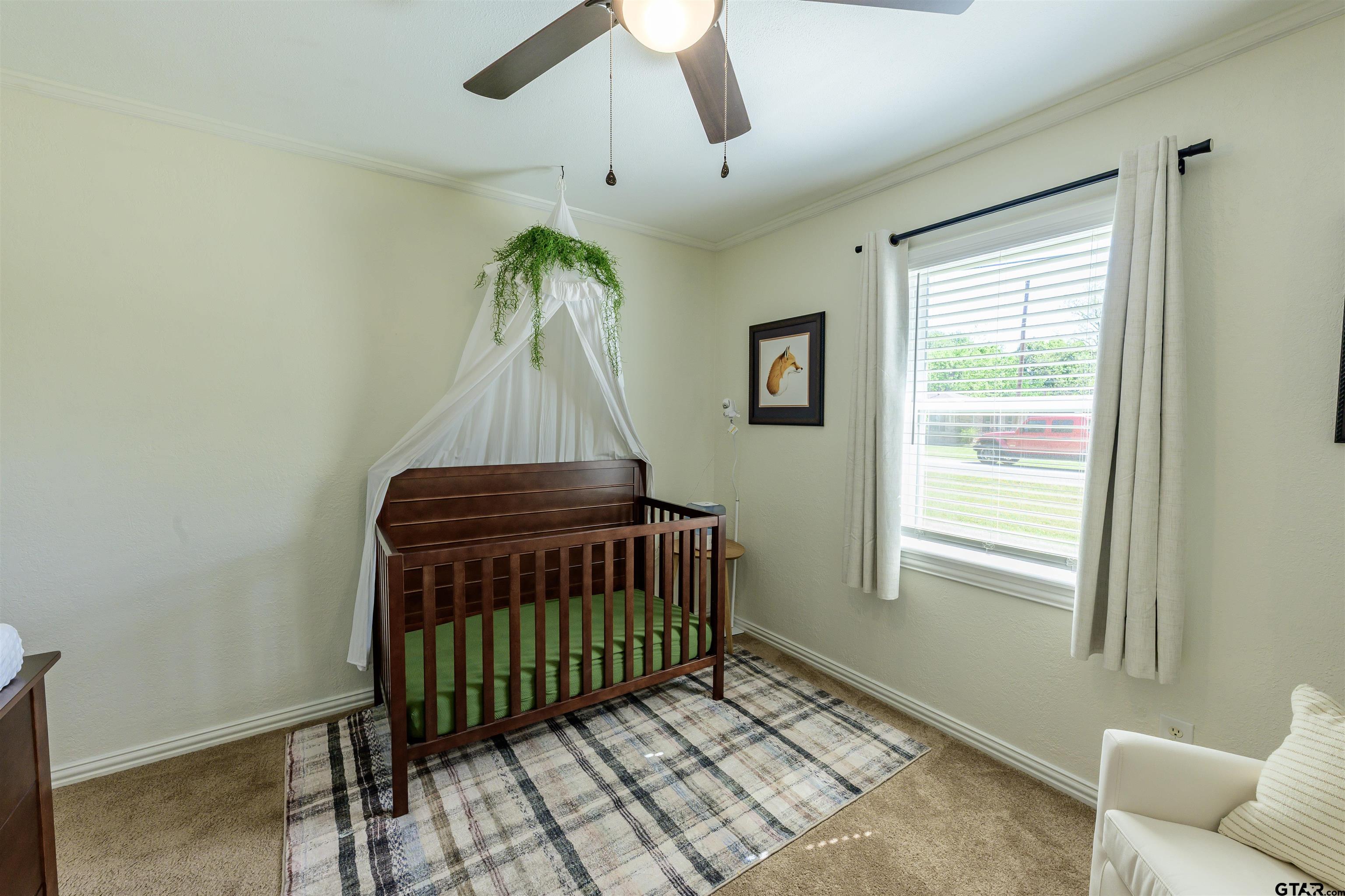 5921 Springbrook Drive Tyler, TX 75707 - Photo 20 of 39 a room with a window and a chandelier