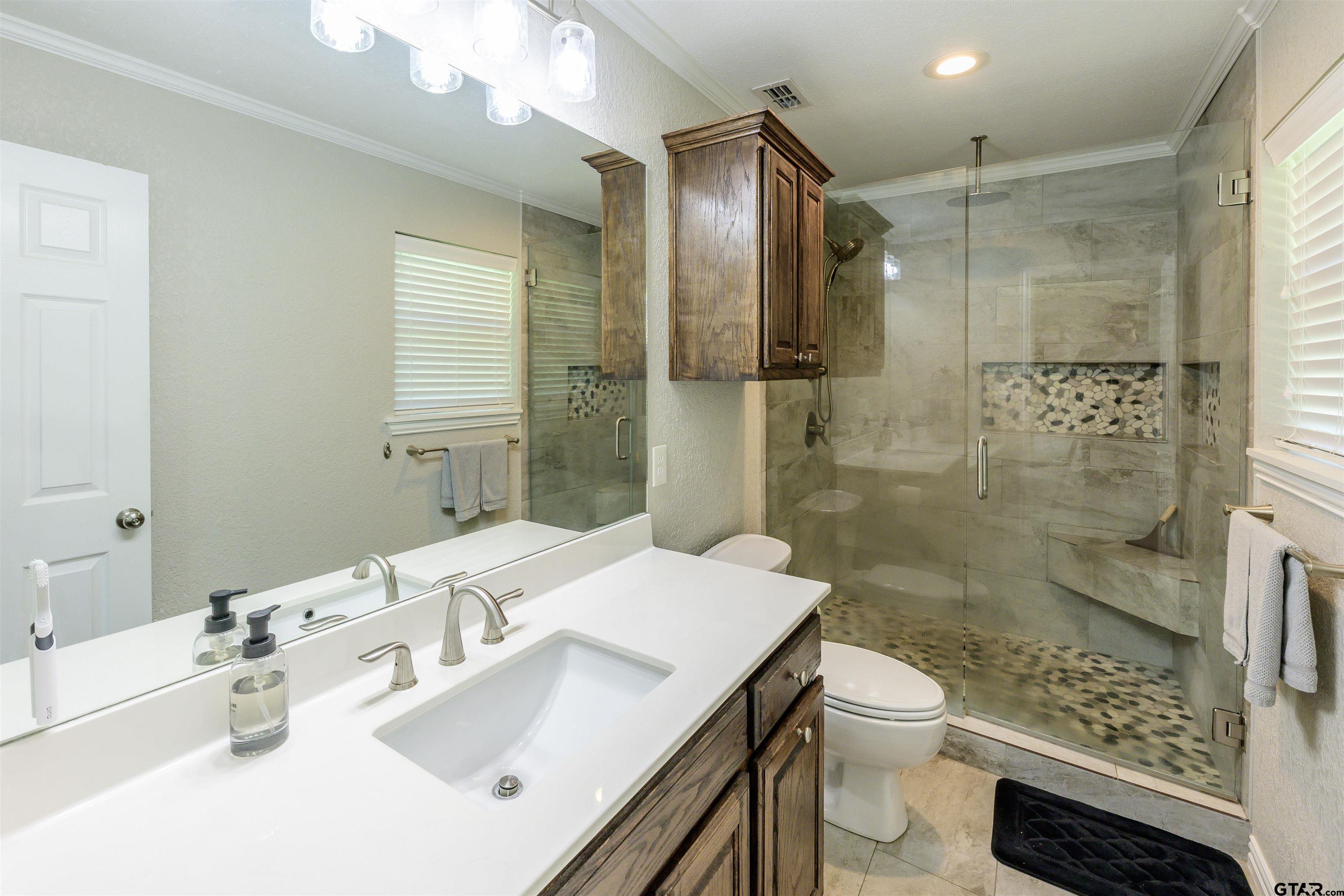 5921 Springbrook Drive Tyler, TX 75707 - Photo 30 of 39 a bathroom with a sink toilet and shower