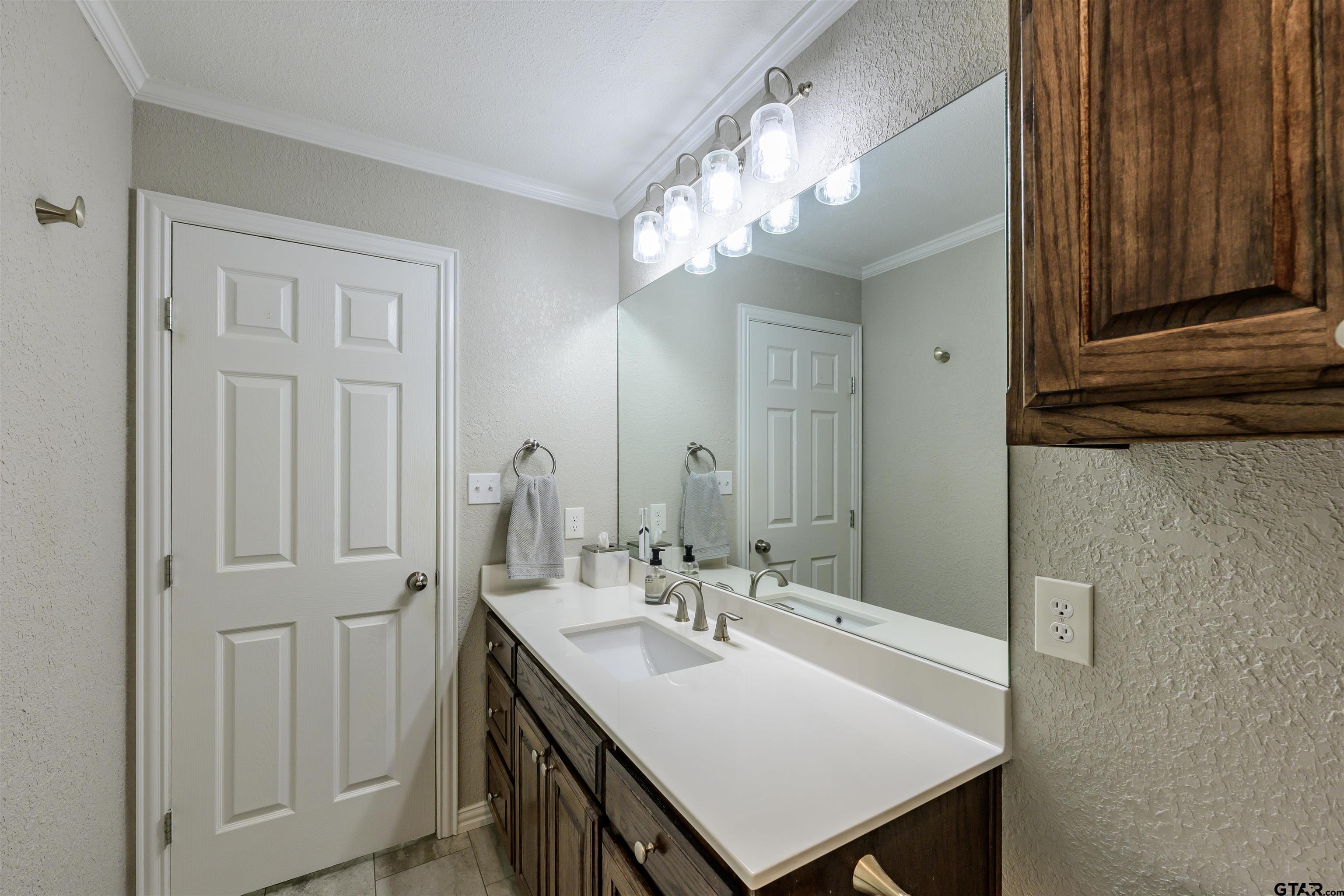 5921 Springbrook Drive Tyler, TX 75707 - Photo 31 of 39 a bathroom with a sink vanity and a mirror