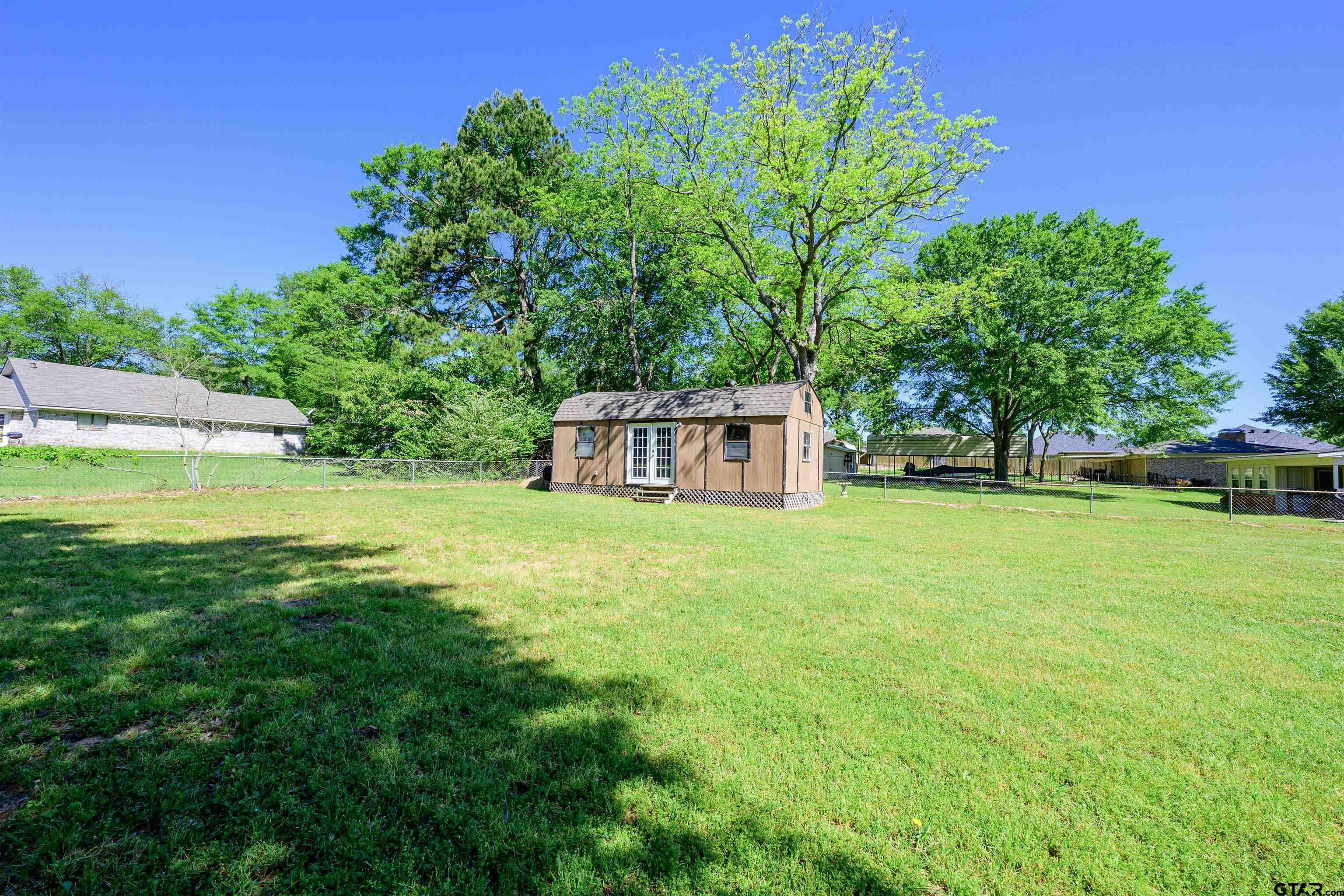 5921 Springbrook Drive Tyler, TX 75707 - Photo 35 of 39 a view of a garden with a bench