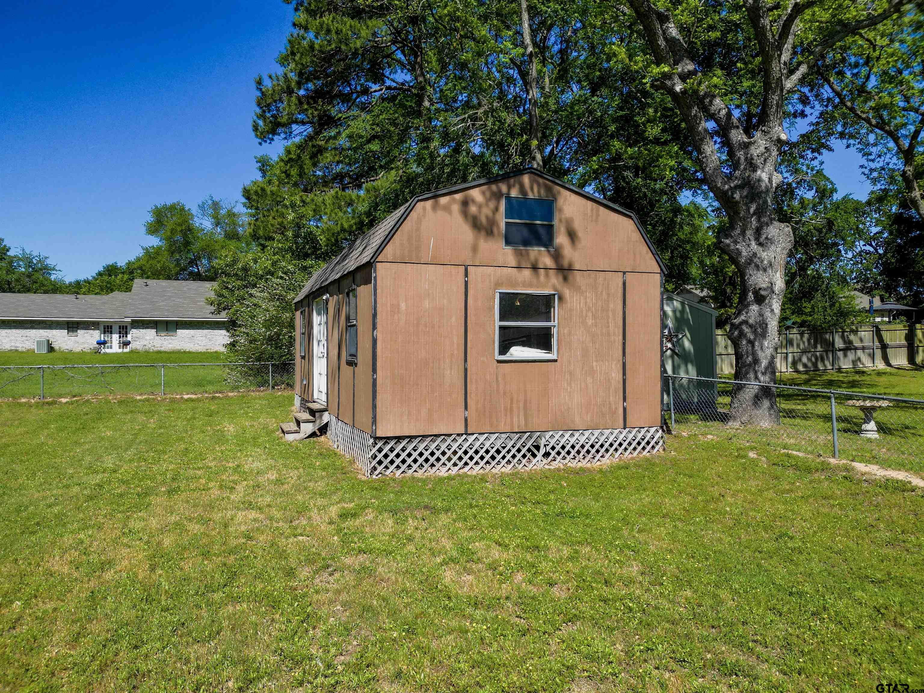 5921 Springbrook Drive Tyler, TX 75707 - Photo 36 of 39 a front view of a house with a yard
