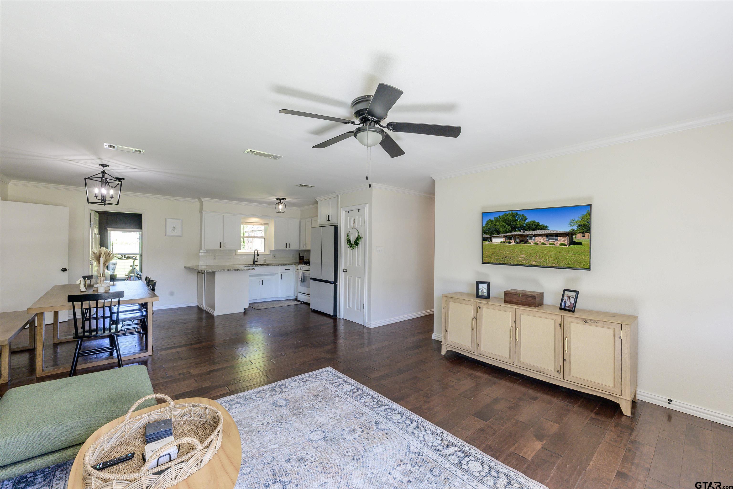 5921 Springbrook Drive Tyler, TX 75707 - Photo 4 of 39 a living room with furniture and a wooden floor