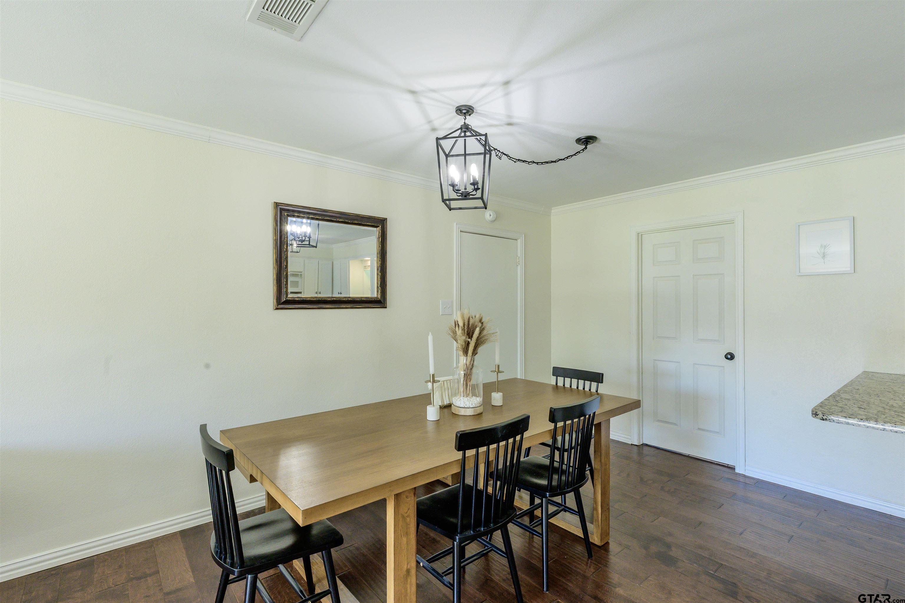 5921 Springbrook Drive Tyler, TX 75707 - Photo 8 of 39 a view of a dining room with furniture and wooden floor