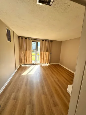 a view of wooden floor and brick walls