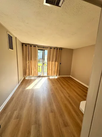 a view of wooden floor and brick walls