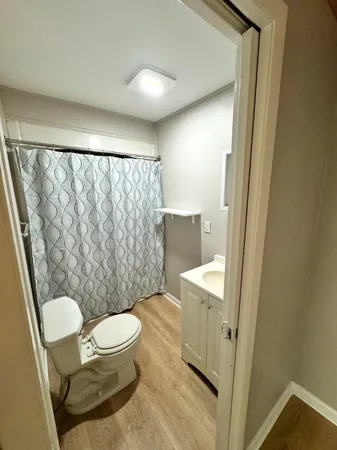 a bathroom with a toilet a sink and a shower