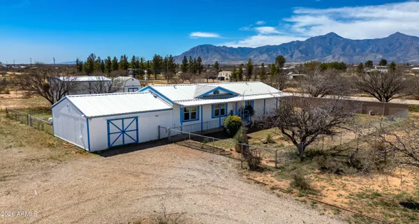 a view of a house with a yard and mountain view