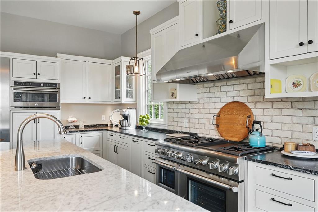 743 Chestnut Road Sewickley, PA 15143 - Photo 12 of 40 a kitchen with granite countertop a stove sink and cabinets