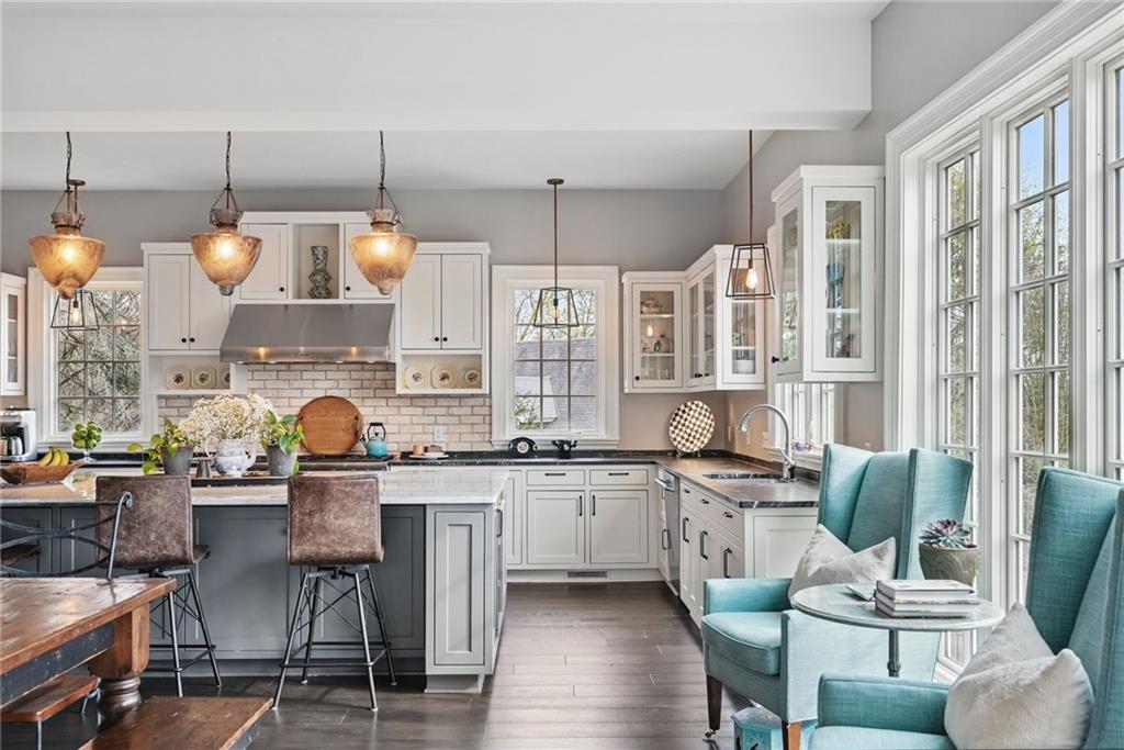 743 Chestnut Road Sewickley, PA 15143 - Photo 14 of 40 a kitchen with stainless steel appliances a table chairs and a refrigerator