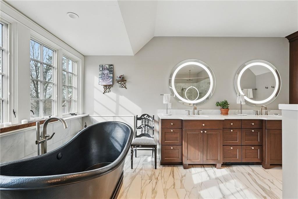 743 Chestnut Road Sewickley, PA 15143 - Photo 23 of 40 a spacious bathroom with a granite countertop double vanity and a mirror
