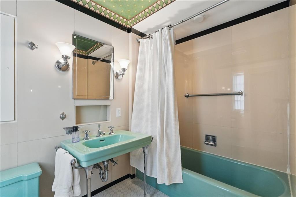 743 Chestnut Road Sewickley, PA 15143 - Photo 26 of 40 a bathroom with a sink a mirror and a shower