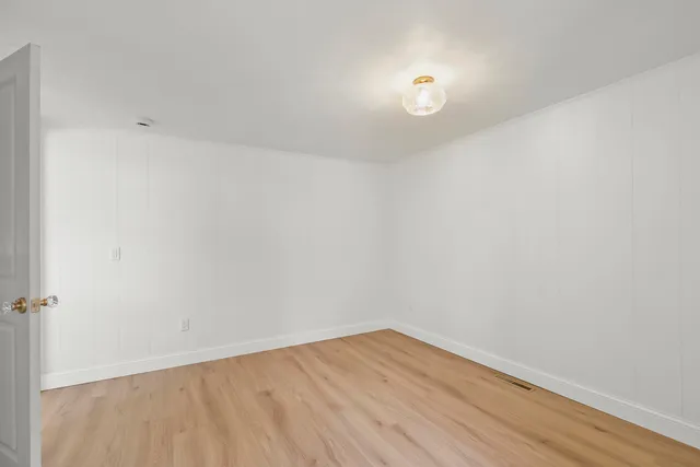 a view of room with wooden floor and fan