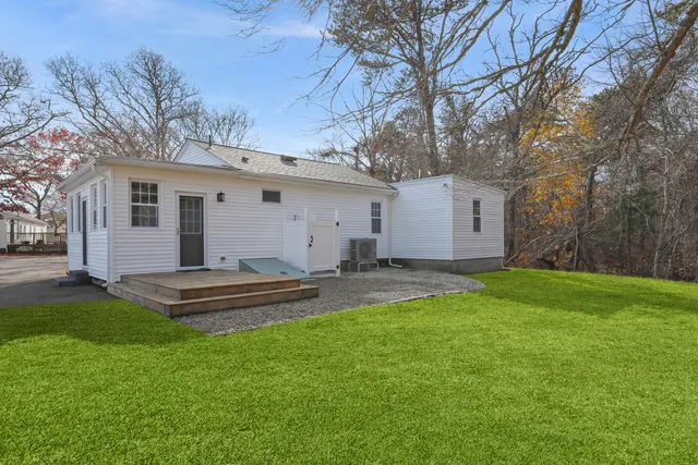 a front view of house with yard and outdoor seating