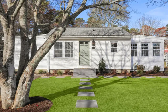a front view of a house with a yard