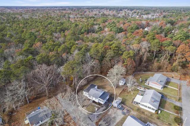 an aerial view of a house with a yard and lake view