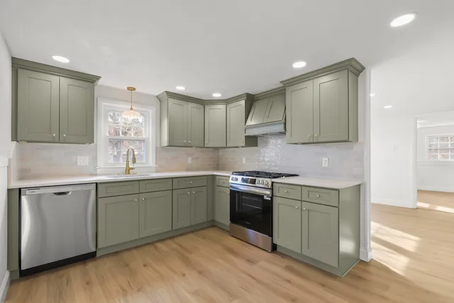 a kitchen with stainless steel appliances granite countertop a sink and stove top oven
