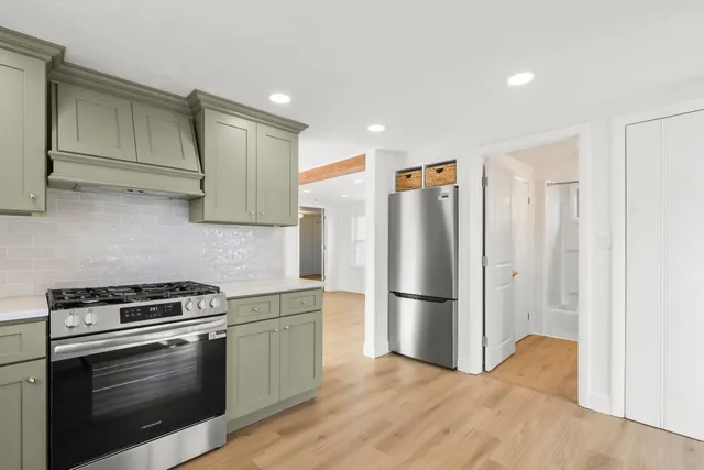 a kitchen with stainless steel appliances a refrigerator stove and microwave