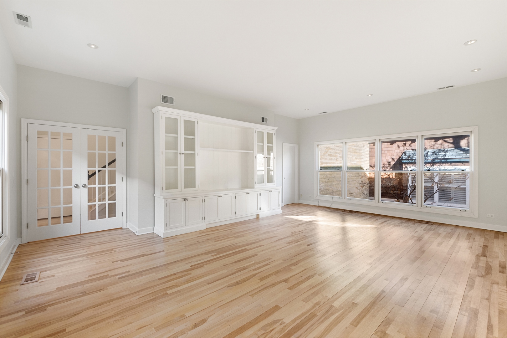 105 Ronan Road Highwood, IL 60040 - Photo 11 of 21 an empty room with wooden floor and windows