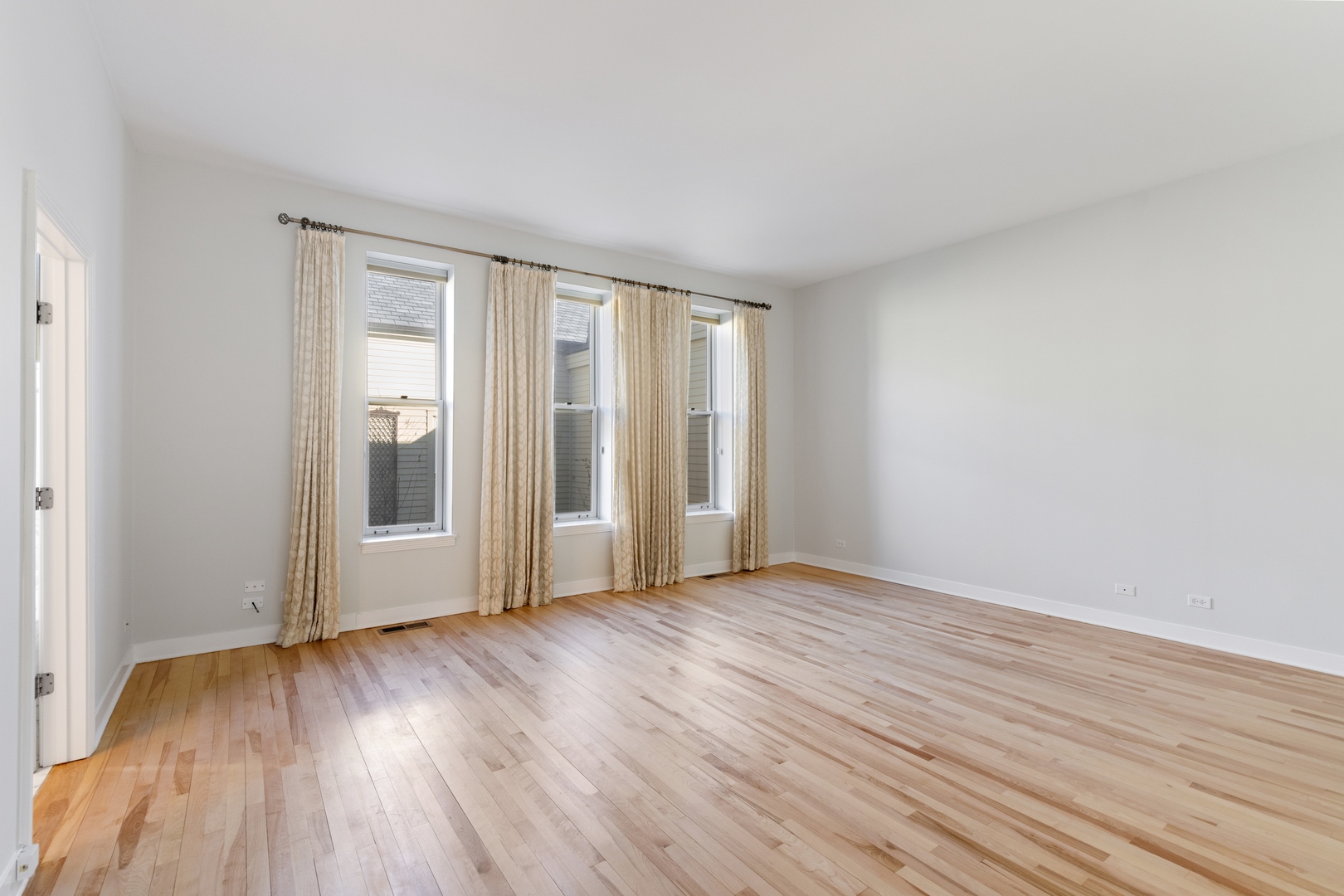 105 Ronan Road Highwood, IL 60040 - Photo 13 of 21 a view of an empty room with wooden floor and a window
