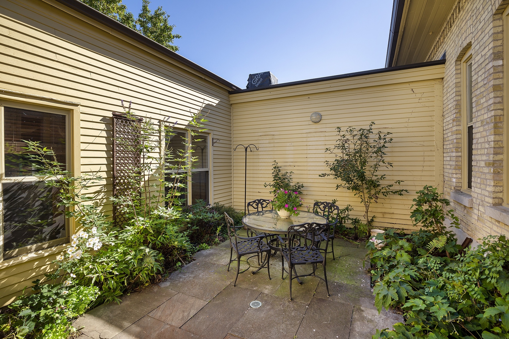 105 Ronan Road Highwood, IL 60040 - Photo 18 of 21 a view of a patio with table and chairs and potted plants