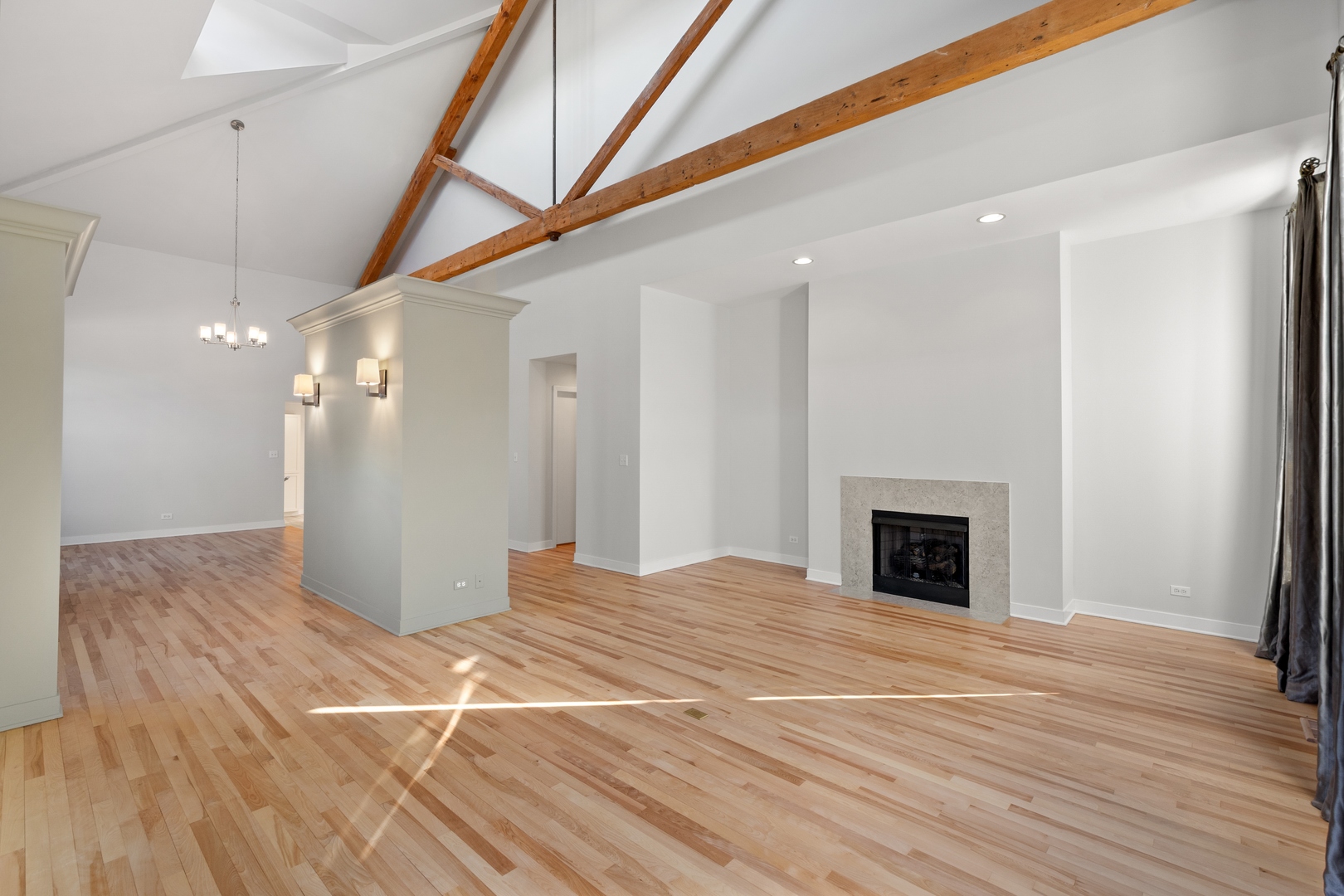 105 Ronan Road Highwood, IL 60040 - Photo 3 of 21 a view of an empty room with wooden floor and a fireplace