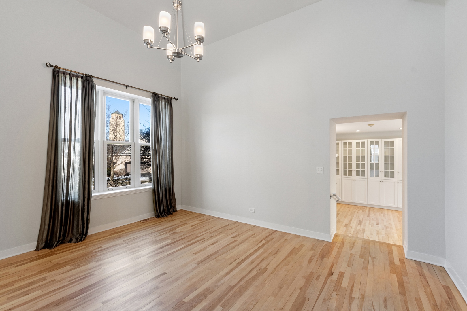 105 Ronan Road Highwood, IL 60040 - Photo 5 of 21 a view of an empty room with a window and wooden floor