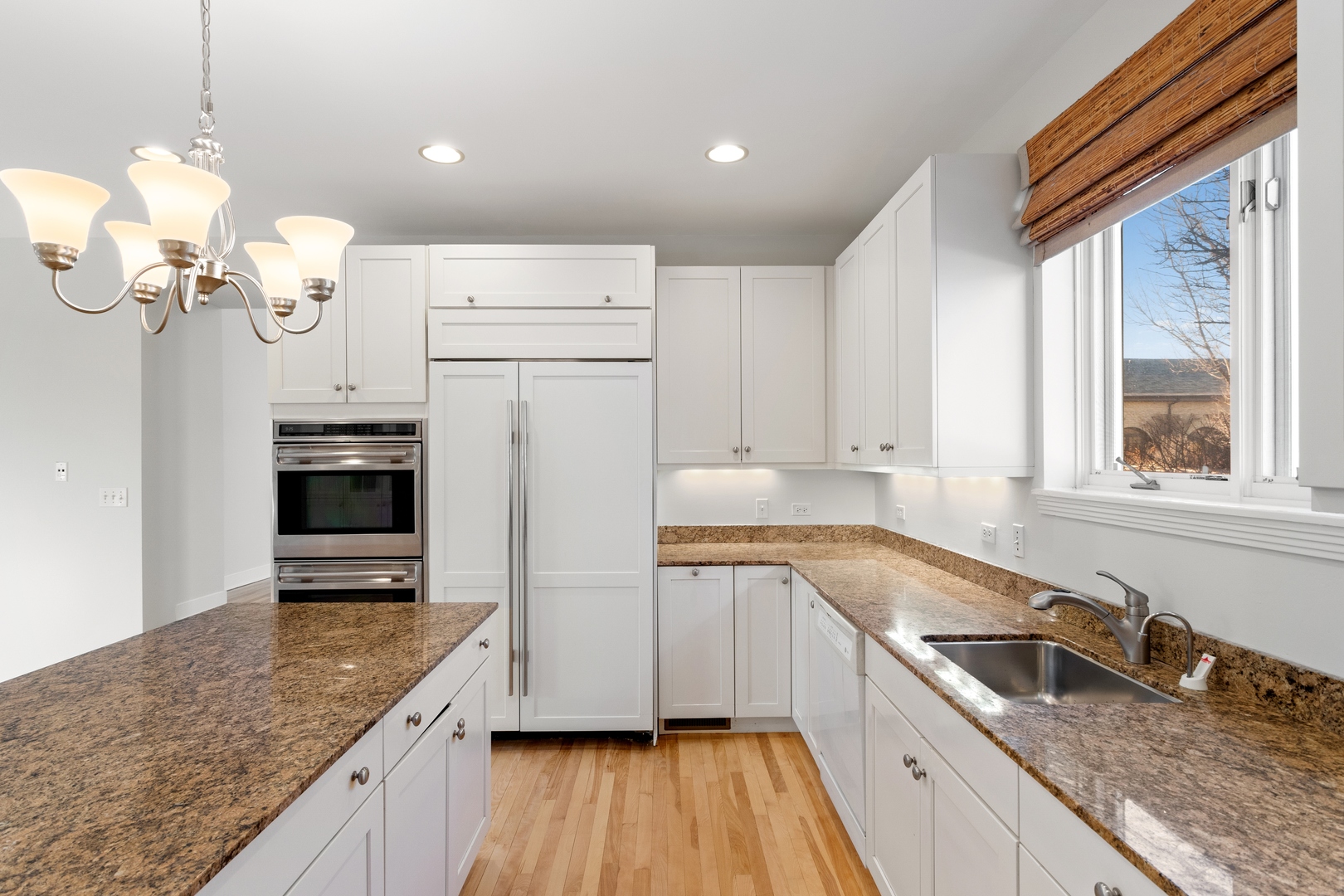 105 Ronan Road Highwood, IL 60040 - Photo 6 of 21 a kitchen with granite countertop a sink cabinets stainless steel appliances and a counter top space