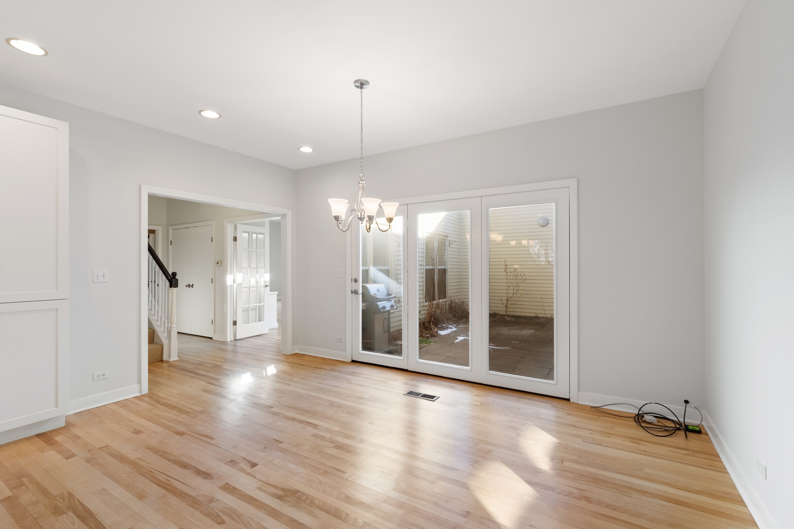 105 Ronan Road Highwood, IL 60040 - Photo 8 of 21 a view of an empty room with wooden floor and a window