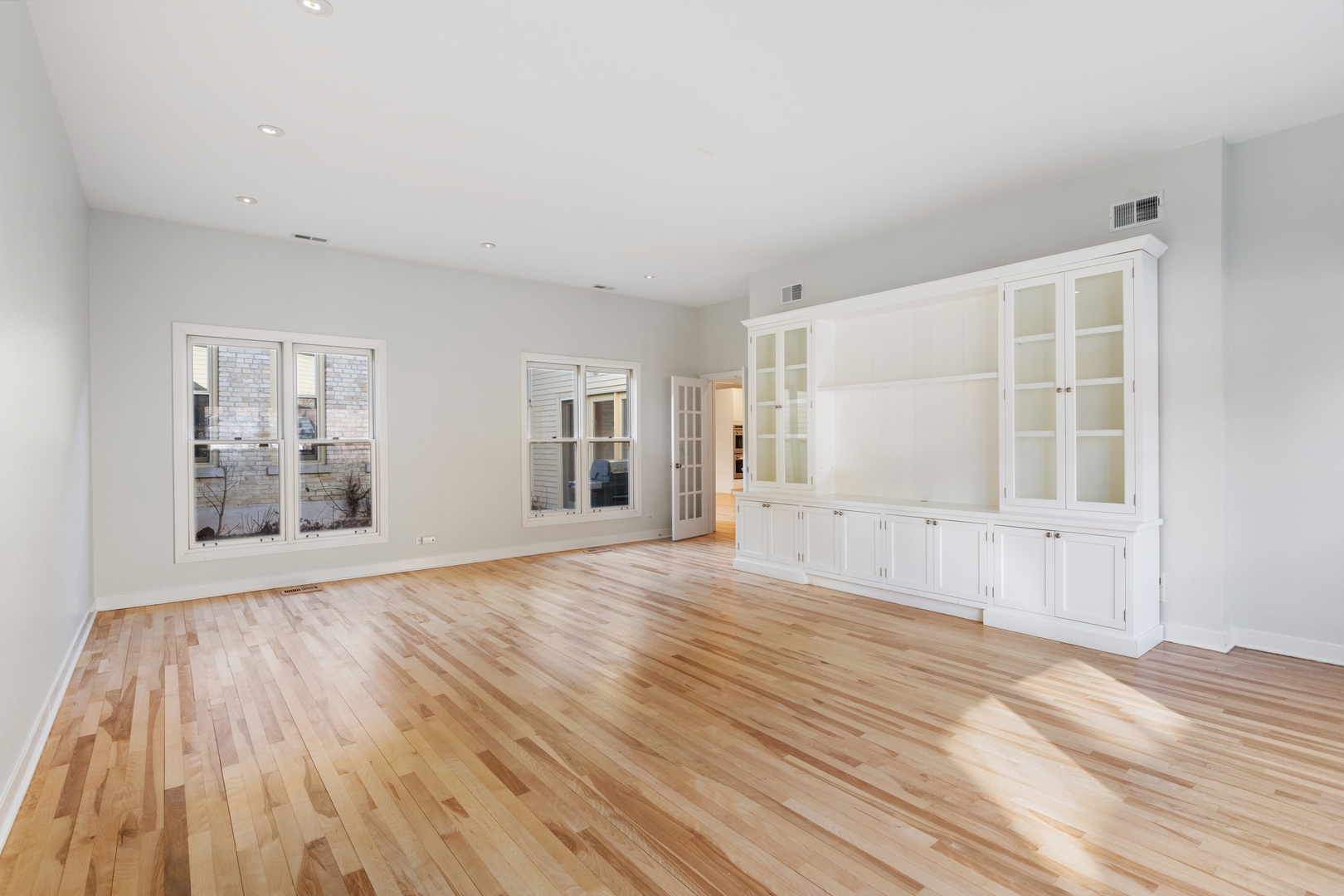 105 Ronan Road Highwood, IL 60040 - Photo 10 of 21 a view of an empty room with wooden floor and a window