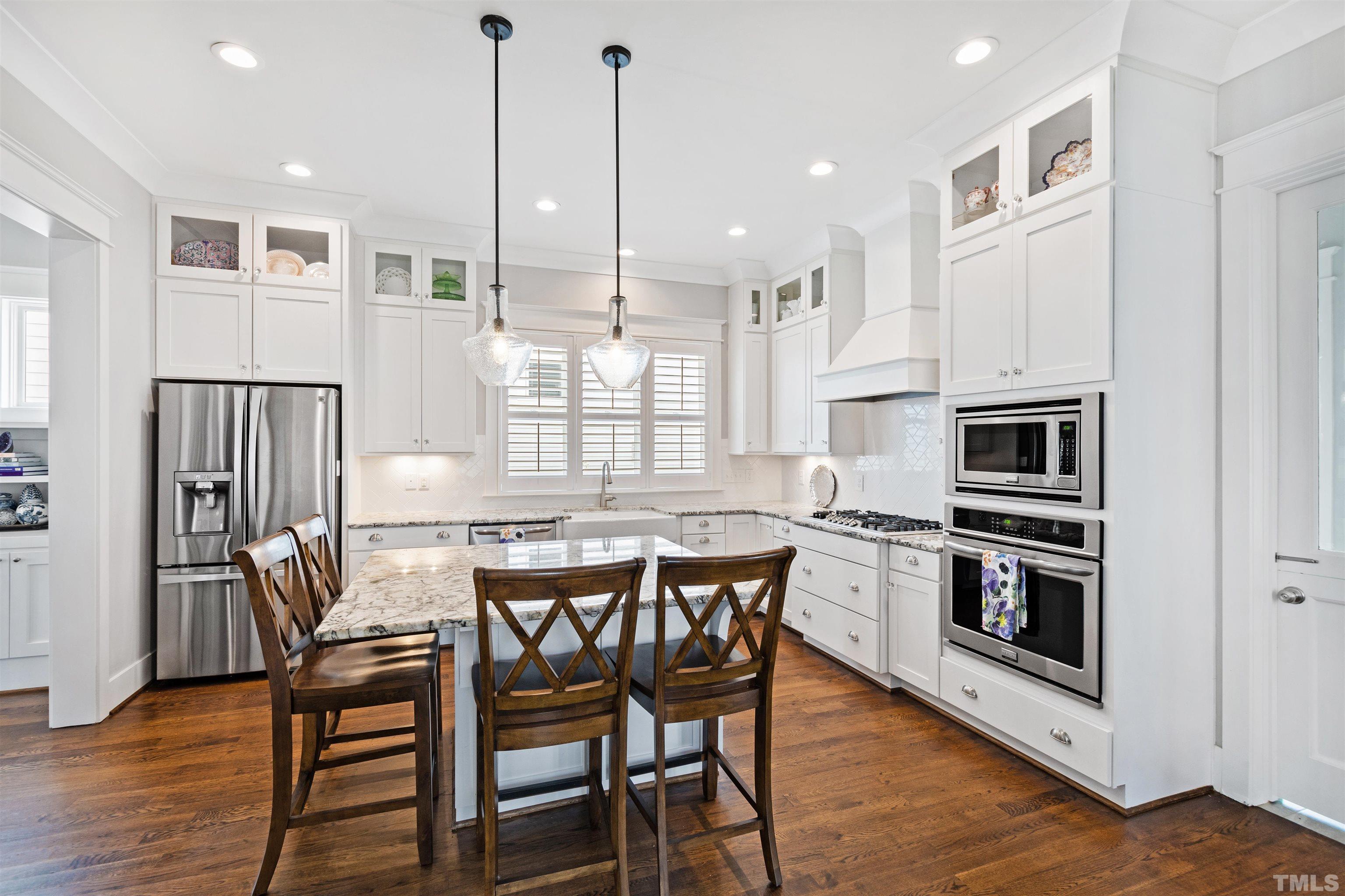 721 Virginia Avenue Raleigh, NC 27604 - Photo 13 of 49 a kitchen with stainless steel appliances granite countertop a kitchen island hardwood floor and a sink