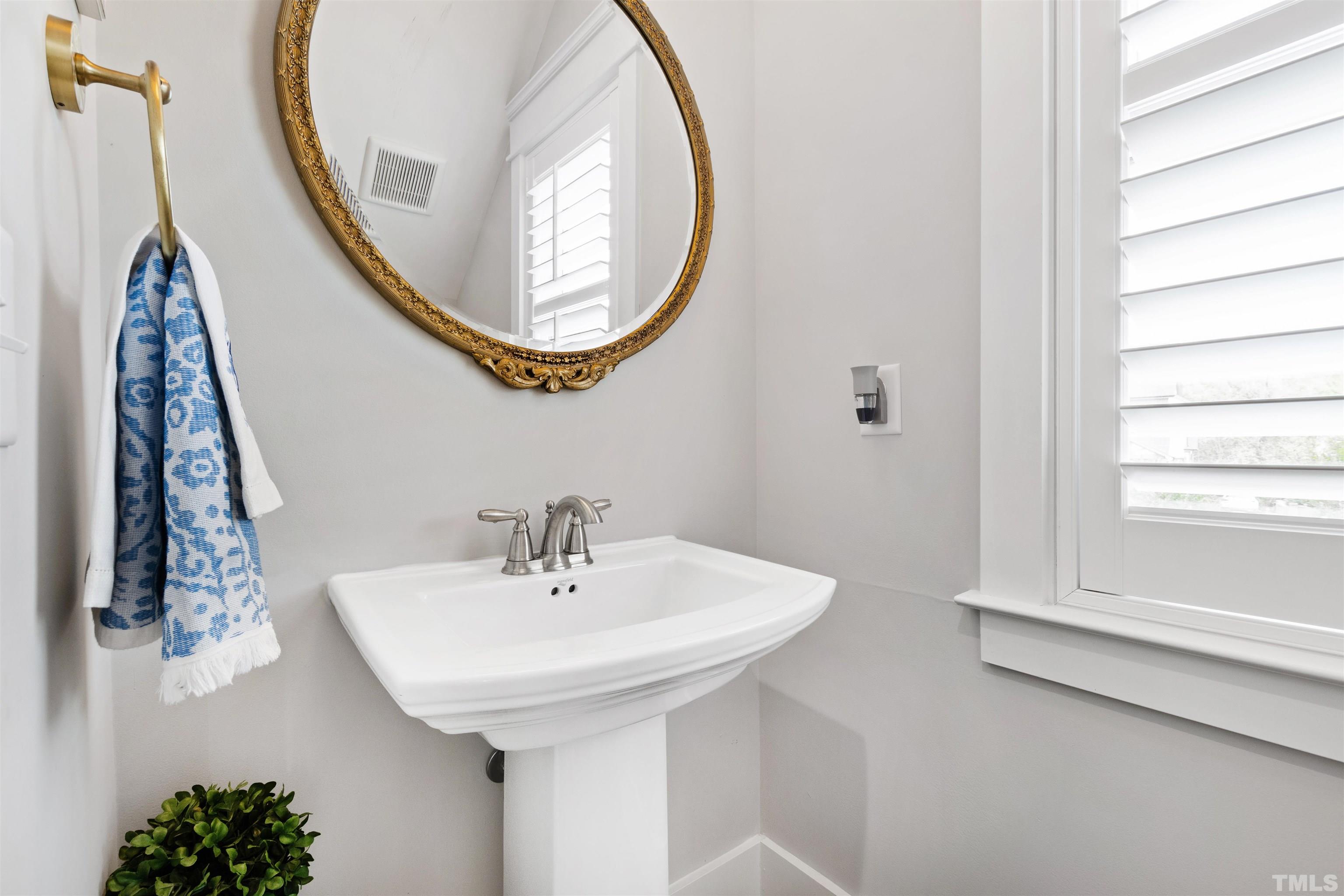 721 Virginia Avenue Raleigh, NC 27604 - Photo 22 of 49 a bathroom with a sink and a mirror