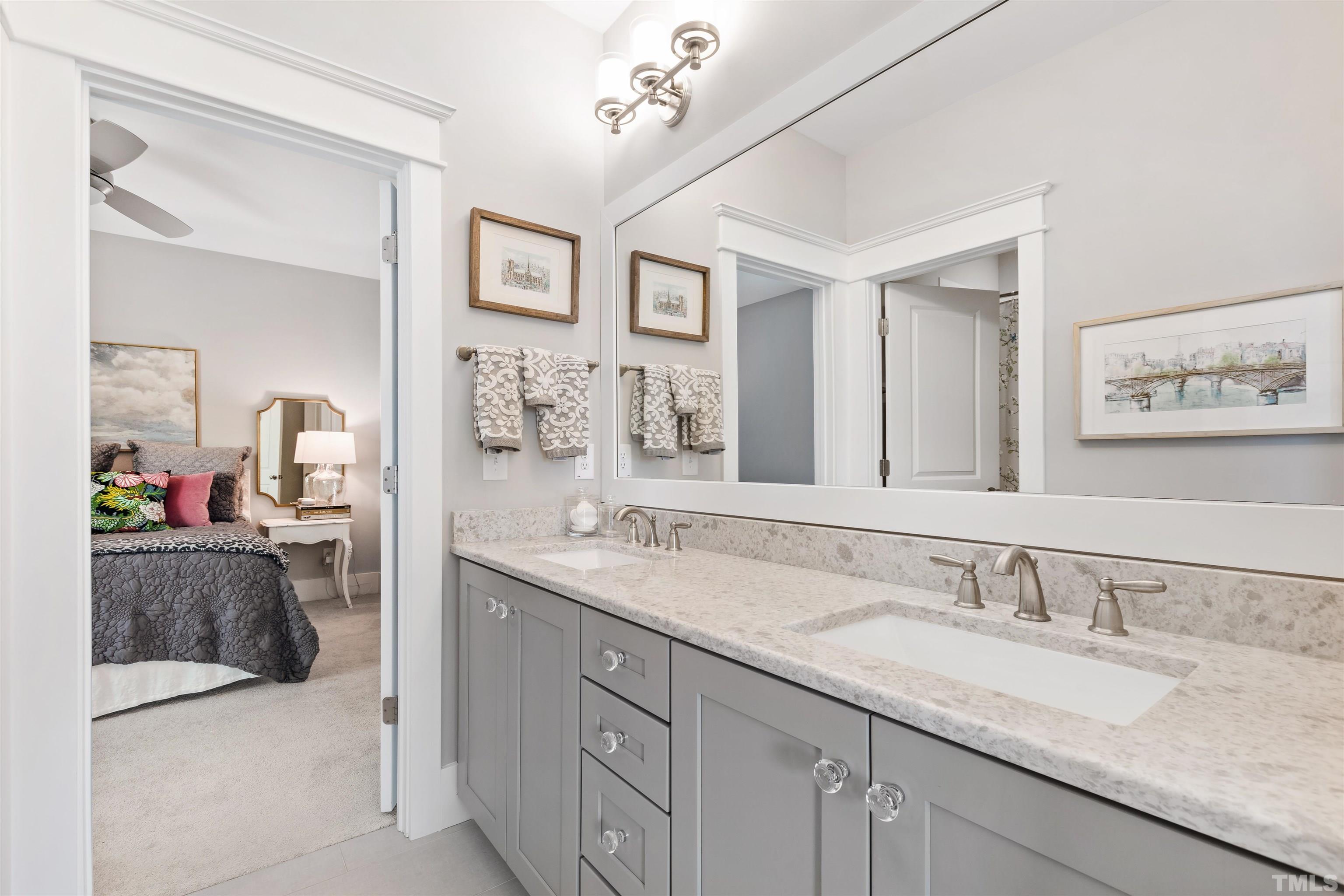 721 Virginia Avenue Raleigh, NC 27604 - Photo 34 of 49 a en suite bathroom with a granite countertop sink and a mirror