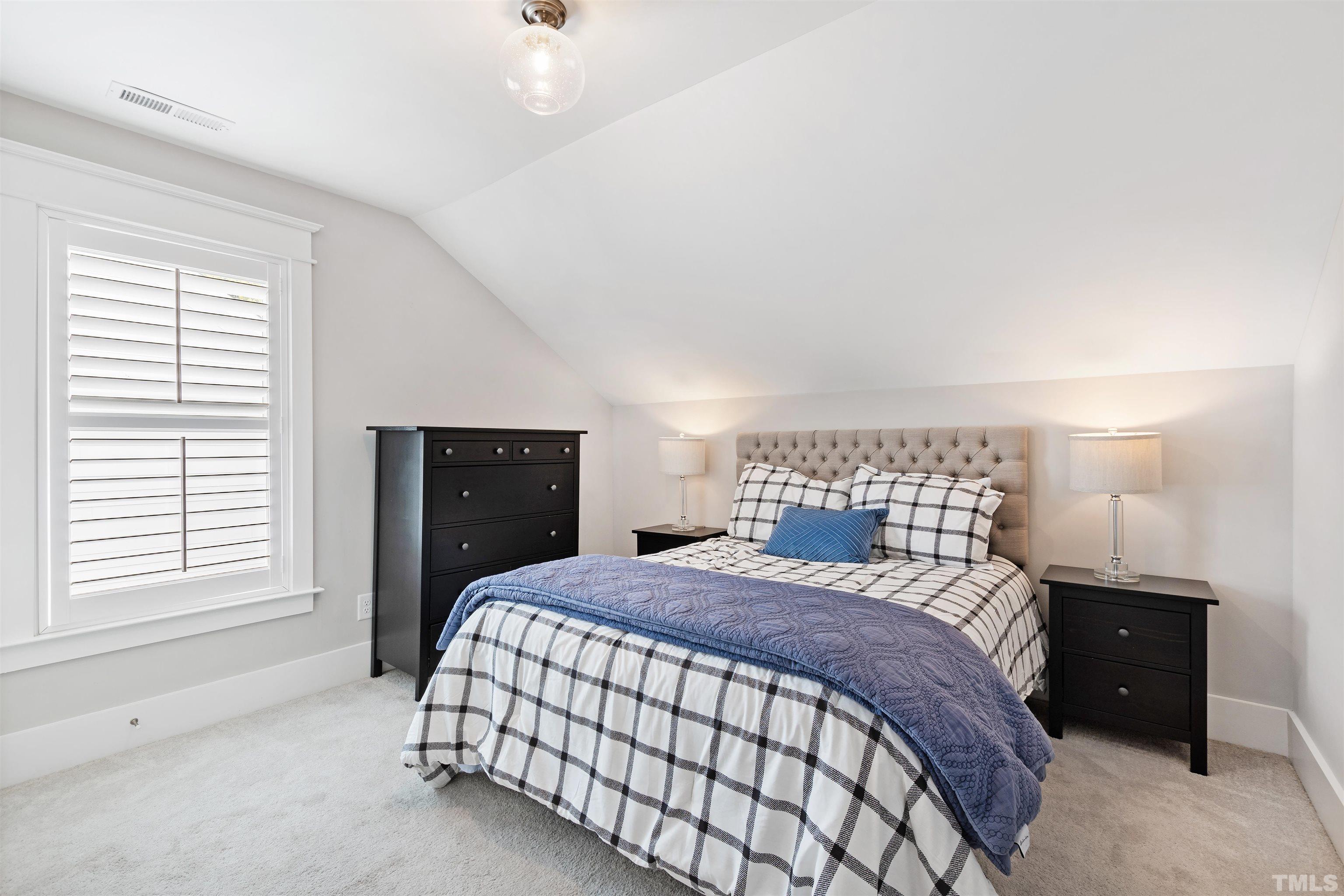 721 Virginia Avenue Raleigh, NC 27604 - Photo 39 of 49 a bedroom with a large bed and a window