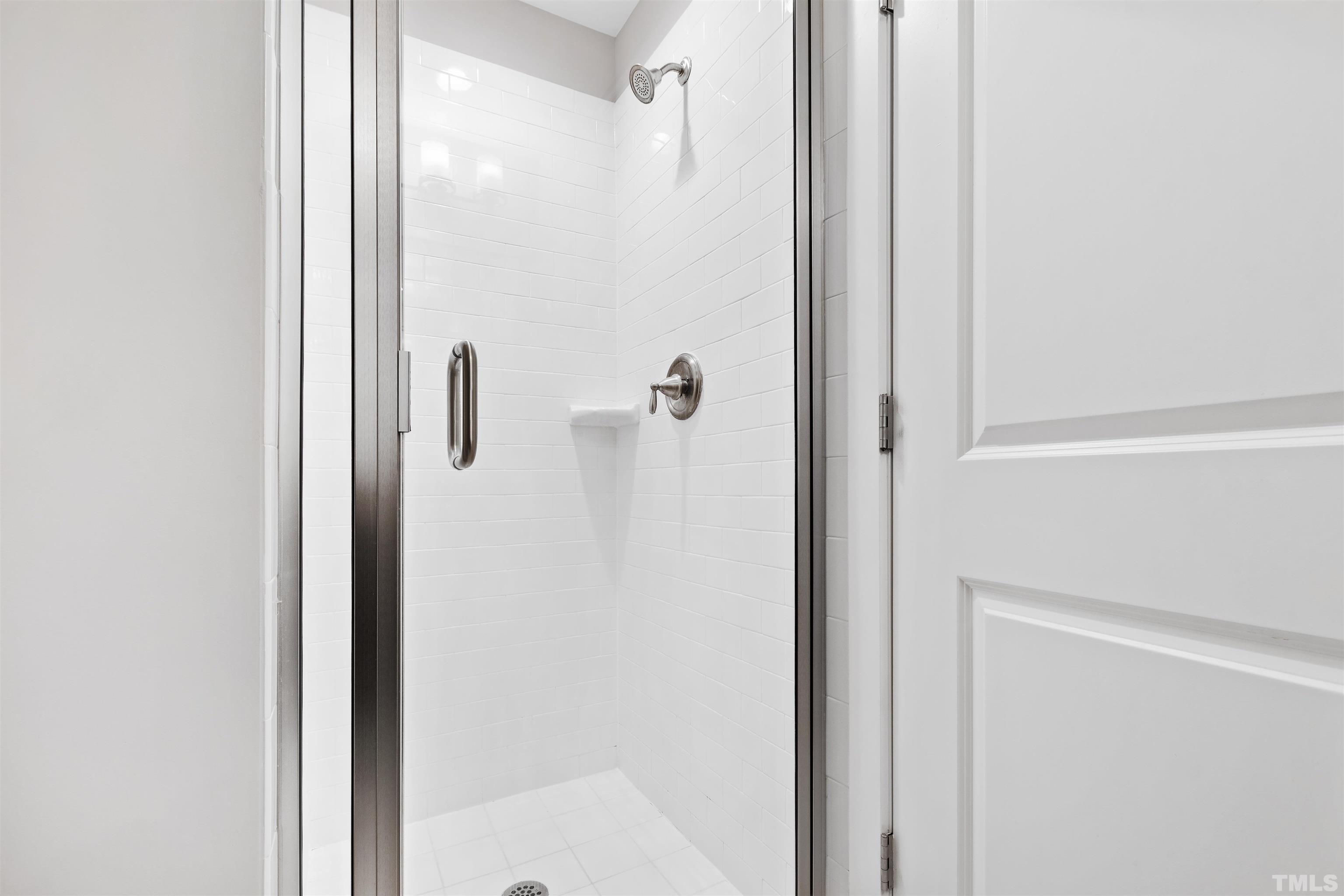 721 Virginia Avenue Raleigh, NC 27604 - Photo 42 of 49 a bathroom with a glass shower door
