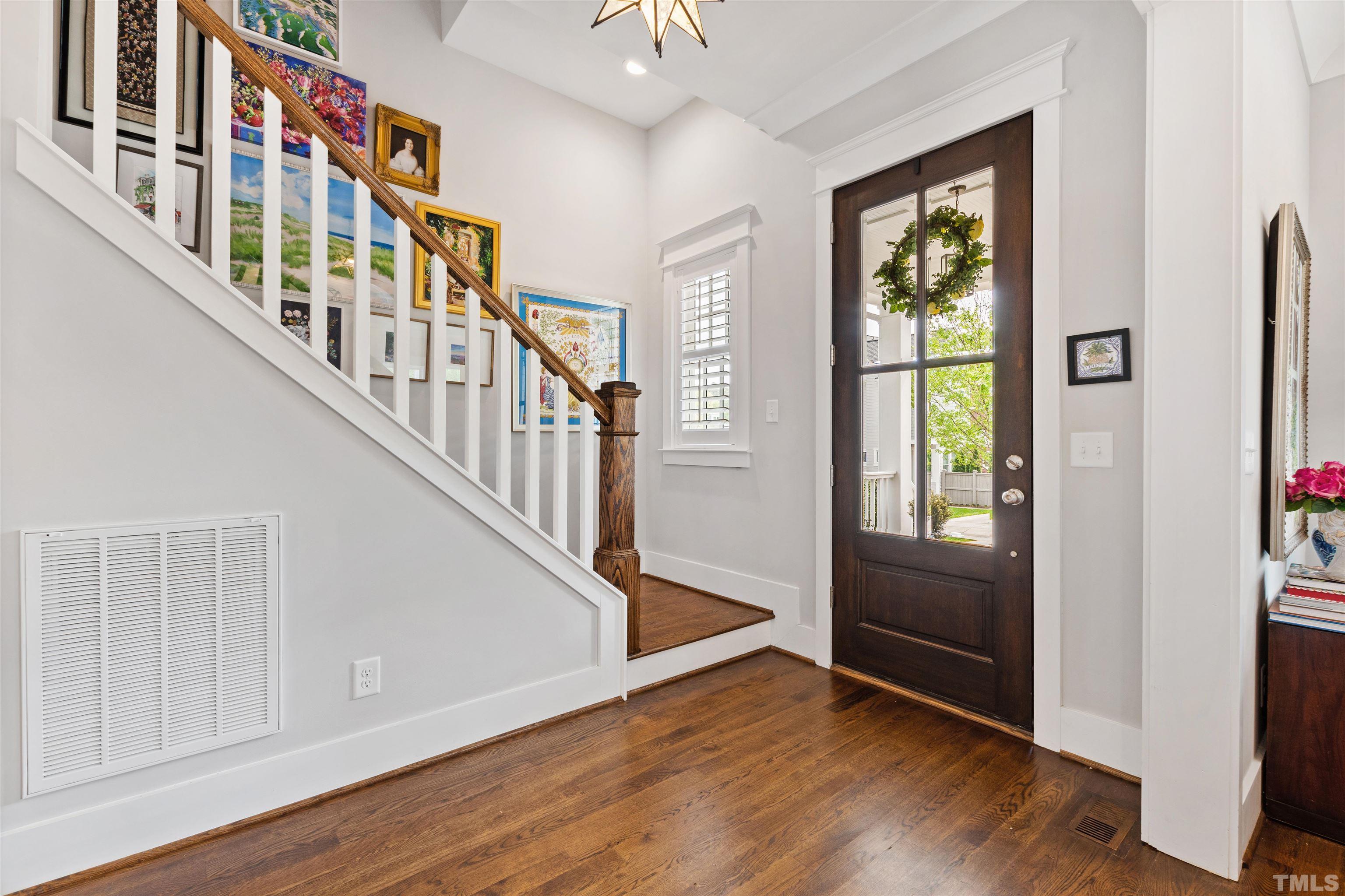 721 Virginia Avenue Raleigh, NC 27604 - Photo 5 of 49 a view of an entryway with wooden floor windows and a livingroom