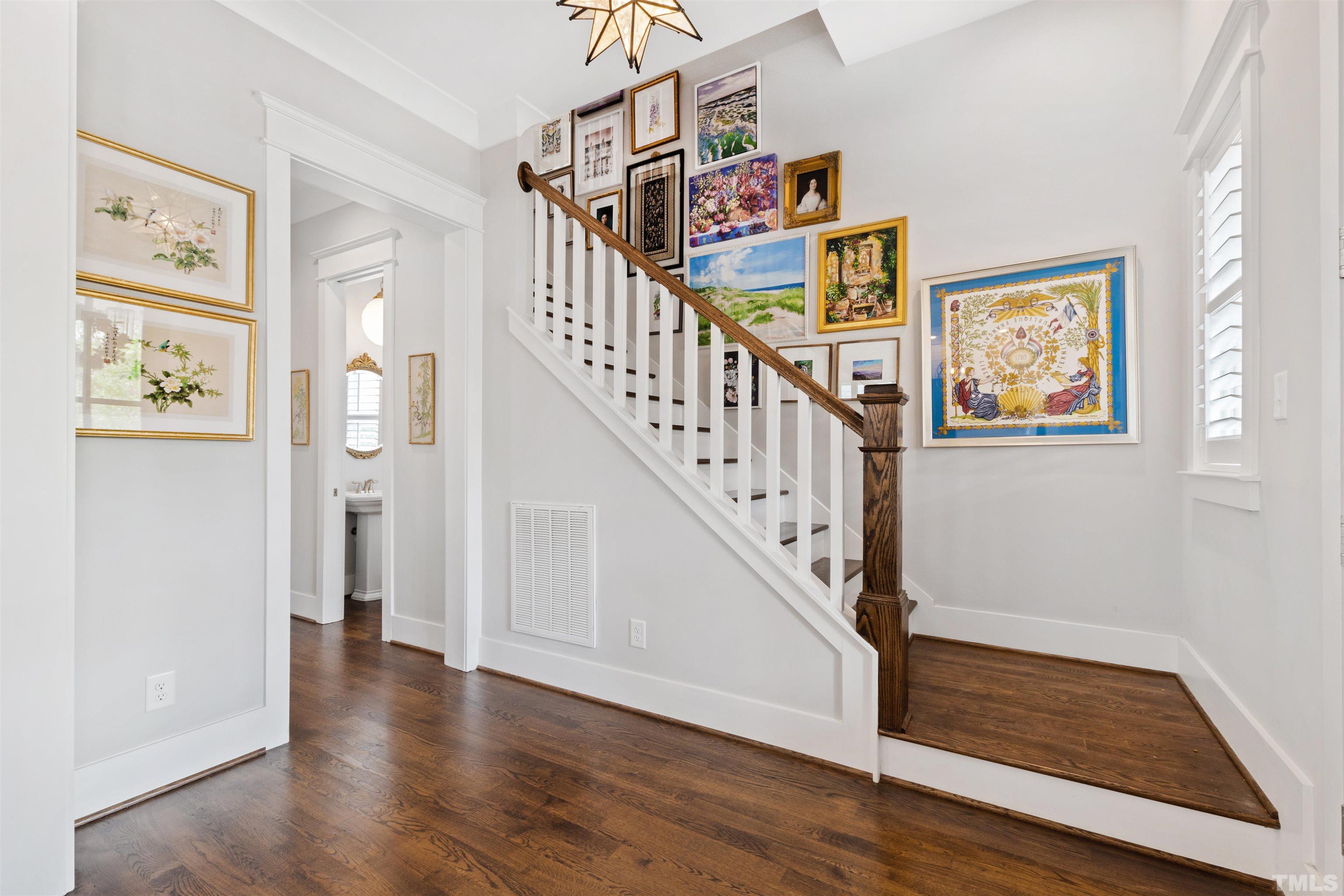 721 Virginia Avenue Raleigh, NC 27604 - Photo 6 of 49 a view of hallway with stairs and wooden floor