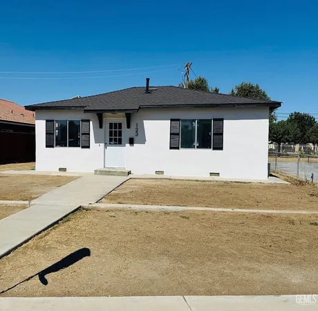 a view of the house with a yard