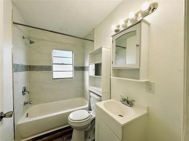 a bathroom with a sink mirror toilet and bathtub